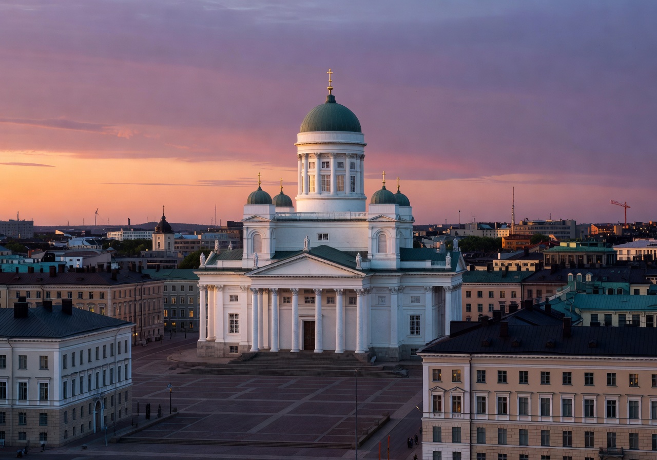Helsinki Cathedral white dome rising above the Finnish capital city skyline at dusk